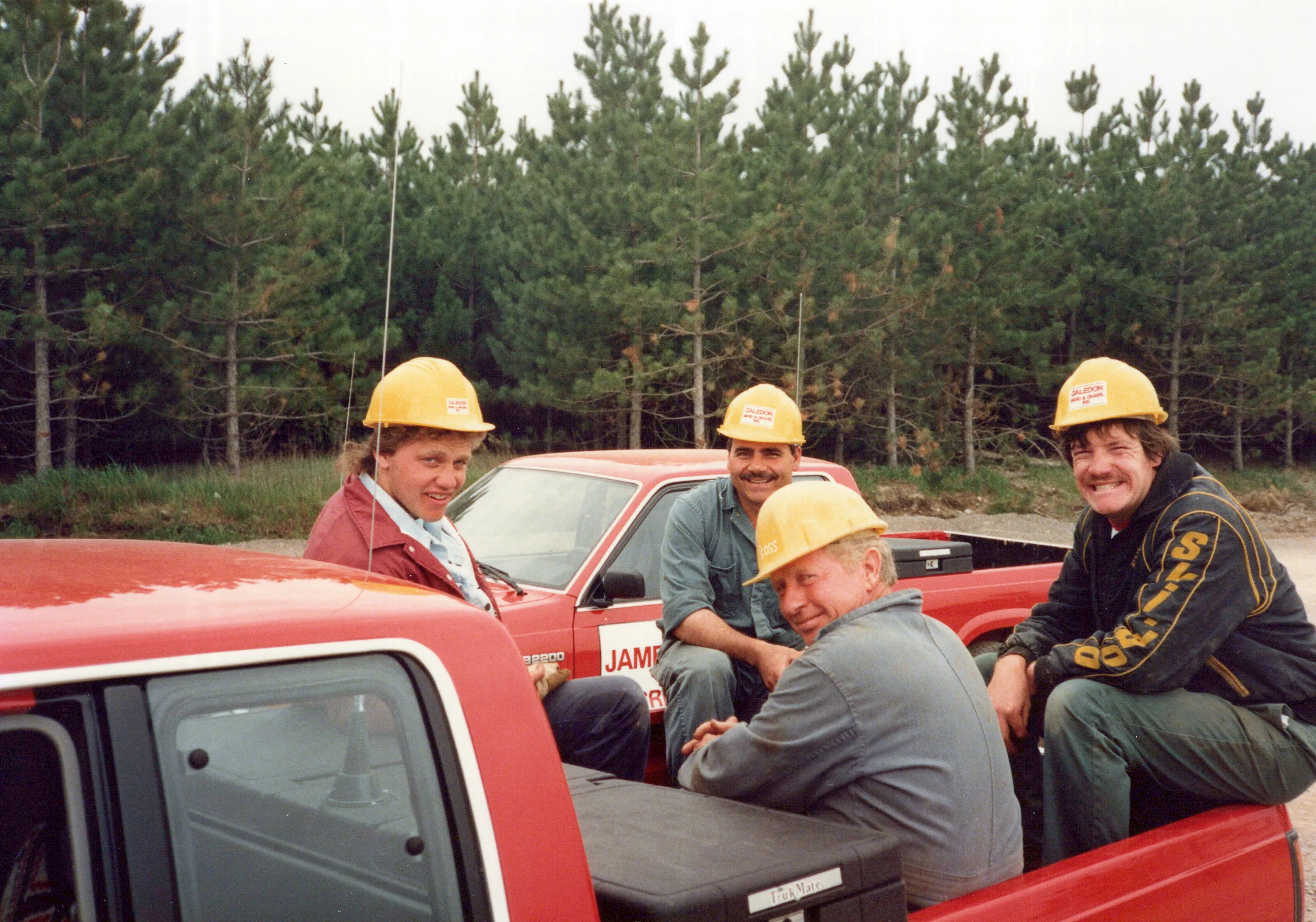 JDA crew gathered around a company pickup truck on site